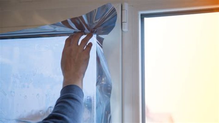 How do you cover windows with aluminum foil?