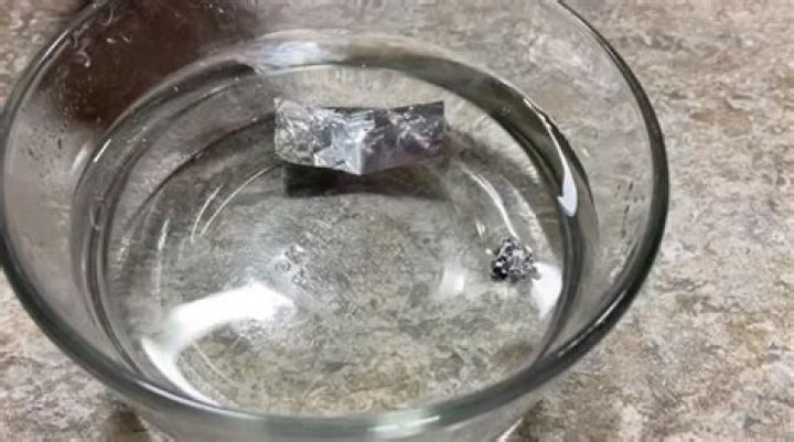 Why does aluminum foil sink in water?